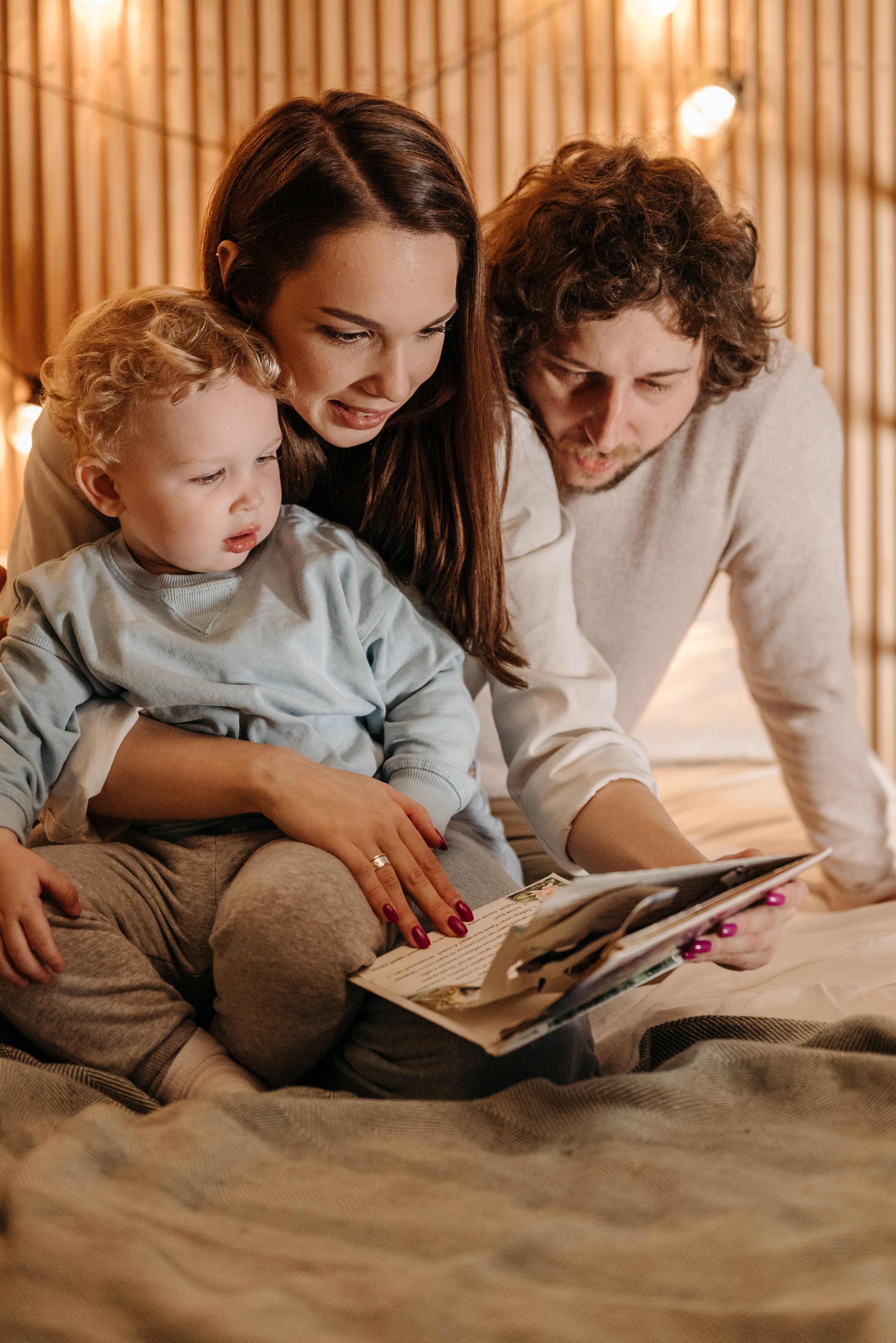 Parents reading together with their young child