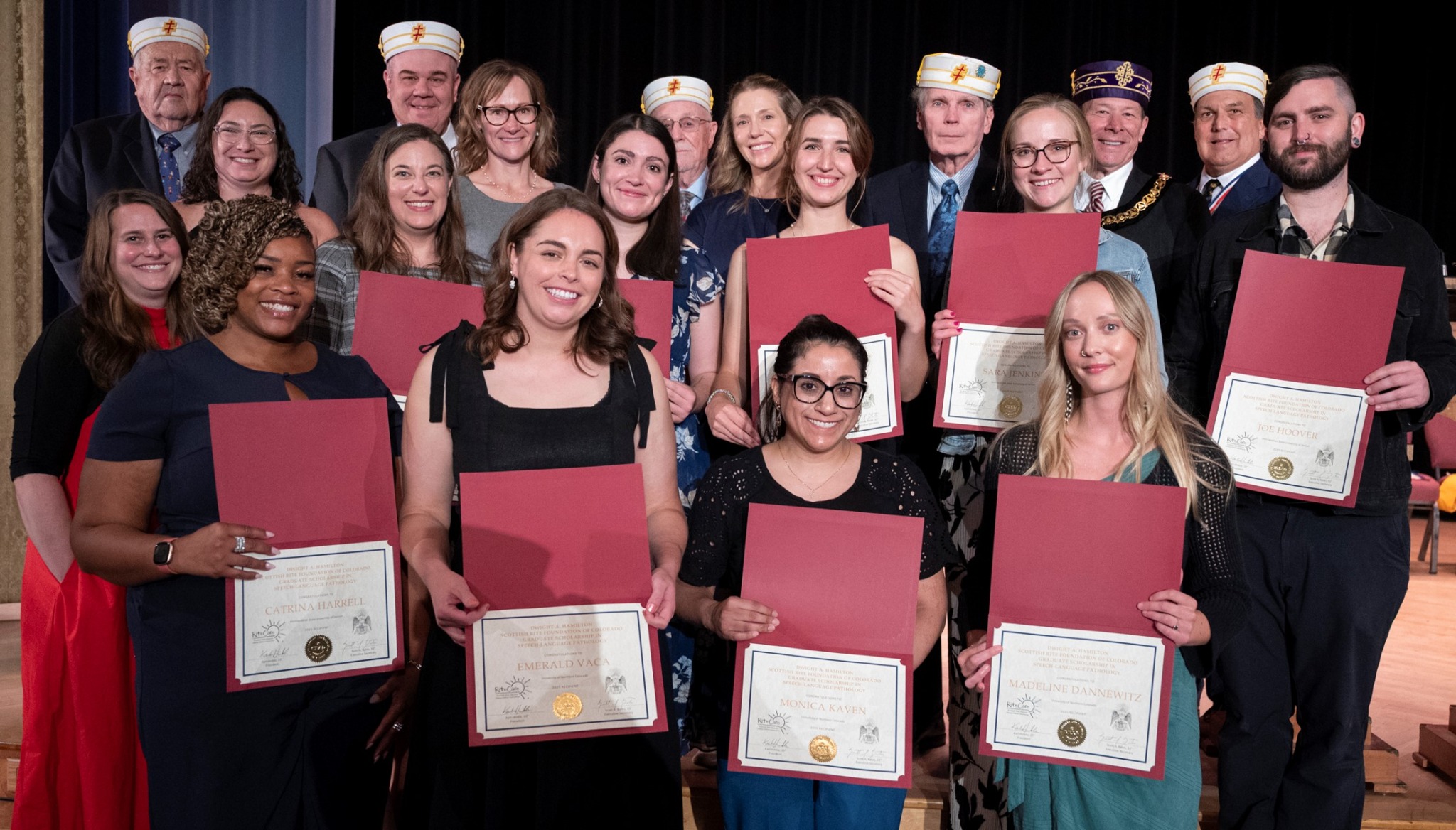Graduate scholarship recipients celebrating with their scholarship certificates
